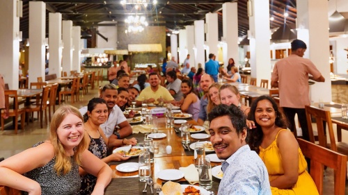 a group of people seated at a table and smiling