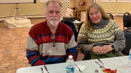 a man and a woman seated at a table indoors