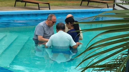 four people in a swimming pool