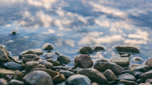 a surface of gray stones slightly covered with water