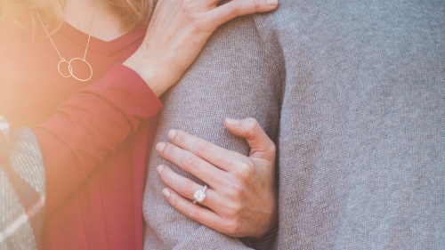 a woman's arm linked through a man's arm