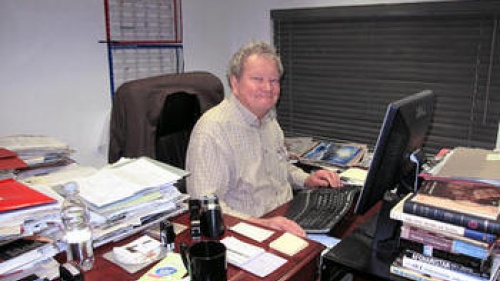 John Ross Schroeder working at his desk.