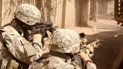 United States troops aiming guns.