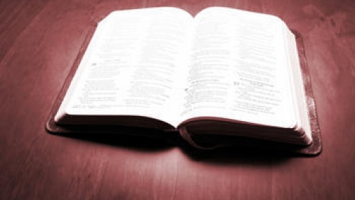 A open Bible laying on a table.