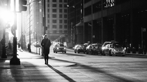 A woman walking on a busy city street.