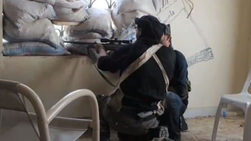 A Syrian rebel sniper in Khan al-Assal, Aleppo province in 2013.
