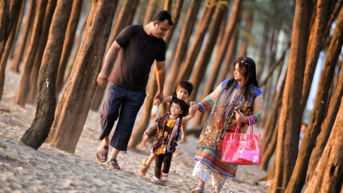 A family walking together on the beach.