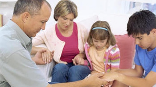 A family praying together.