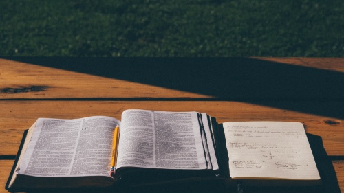 An open Bible on top of a table.