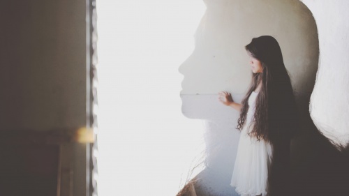 The silhouette of a young woman.