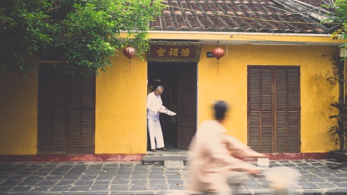 A person standing by their house.