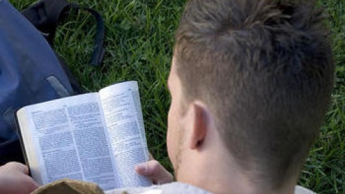 A young man reading the Bible.