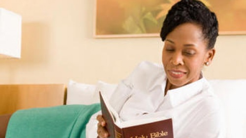 A woman reading a Bible.