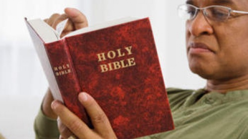 A man reading a Bible.