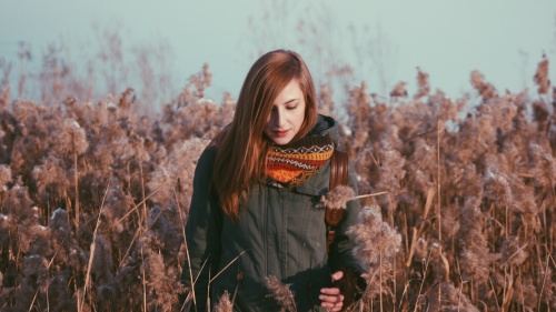 A woman standing in a field of flowers.