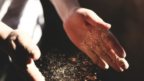 Dust falling out of hands.