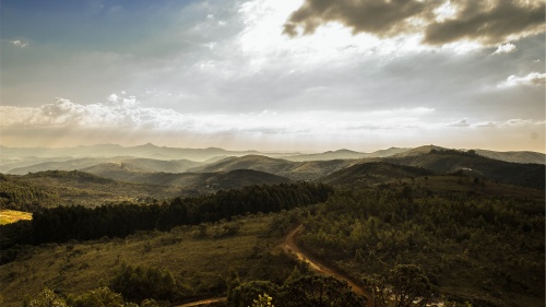 A valley with hills and trees.