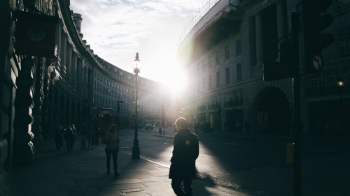 People walking next to a street.