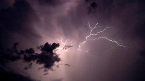 Lightning  strikes in a dark sky.