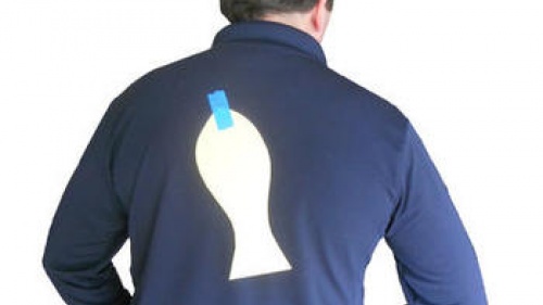 man with paper fish taped on back