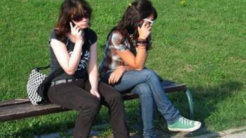 two girls on mobile phones