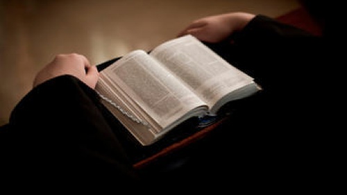 A person reading a Bible.