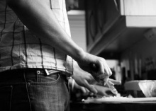 A man preparing food at a kitchen counter.
