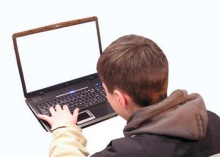 teenage boy using laptop computer