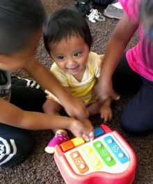 Children playing with a musical toy