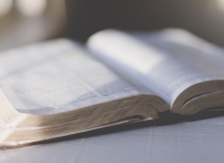 An open Bible on a table.