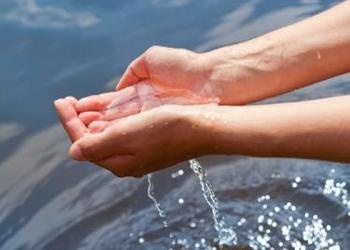 Hands holding water over more water - Understanding God's Word... What the Bible