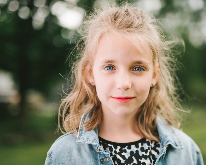 A young girl smiling.