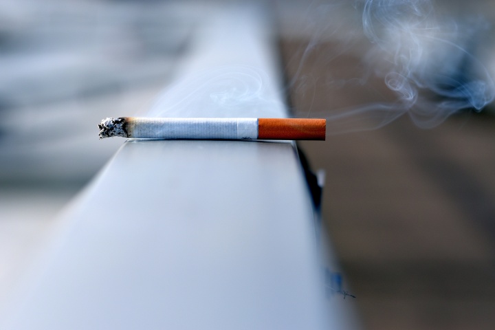 a cigarette balanced on a ledge