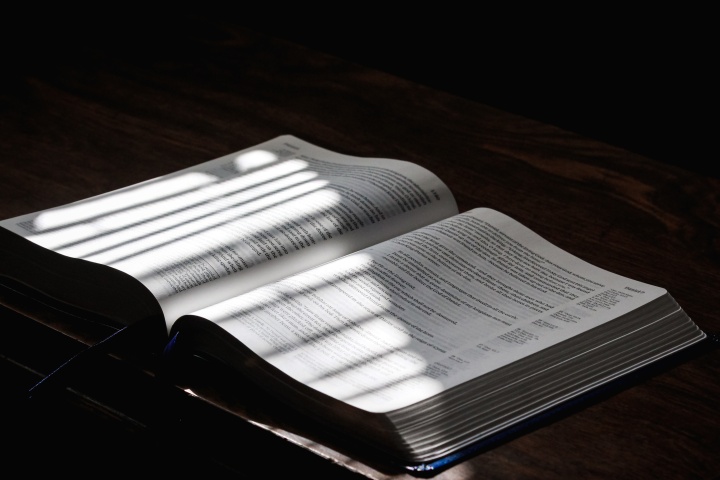 an open Bible with light falling across the pages