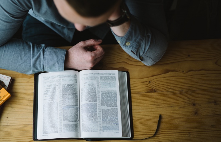 A man reading a Bible.