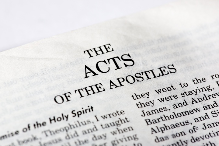 A Bible opened to the book of Acts.