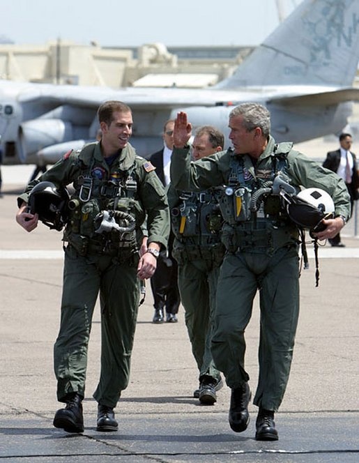 President George W. Bush walks across the tarmac with NFO Lt. Ryan Phillips.