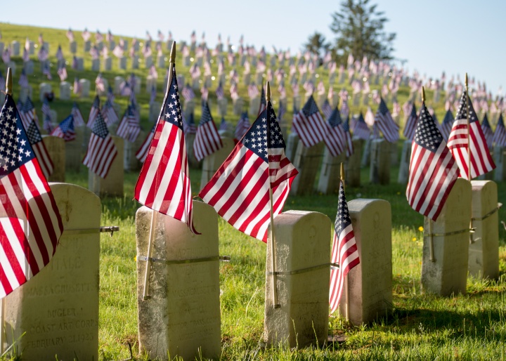 American flags attached to gravestones.