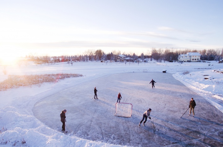 People playing hockey outside.