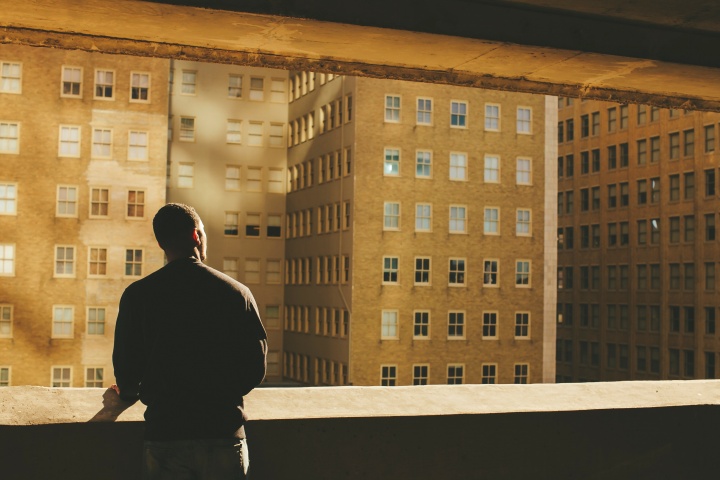 A man looking buildings in a large city.