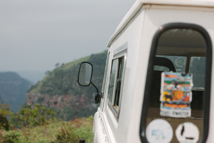 A four wheel drive vehicle with old stickers on the back window.