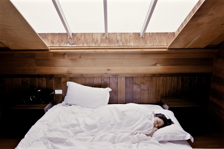 A person sleeping in a bed.