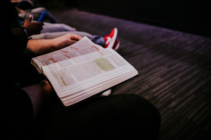 A person holding a Bible.