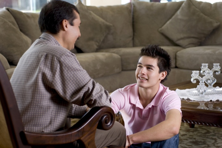 A dad and son talking.