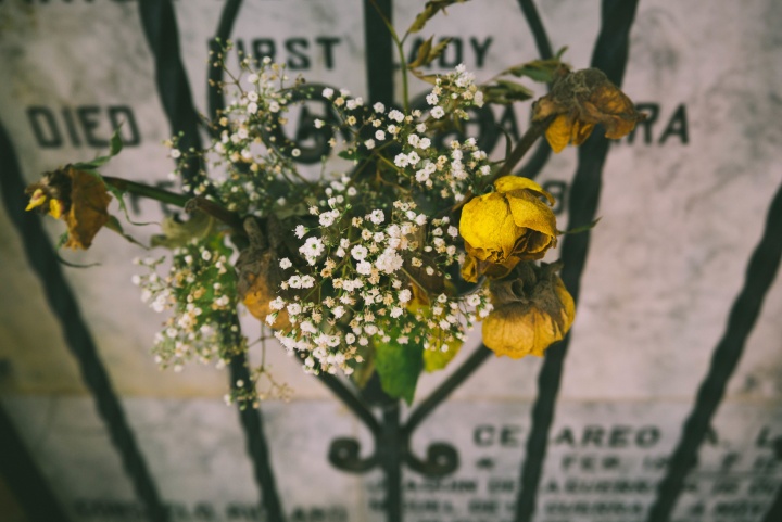 A gravestone and flowers.