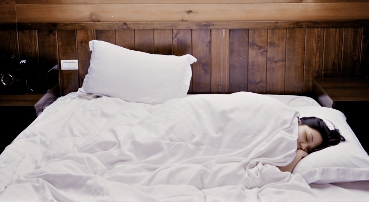 A woman sleeping in a bed.