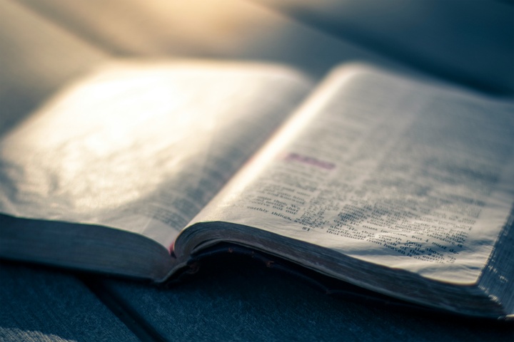 An open Bible on a table.