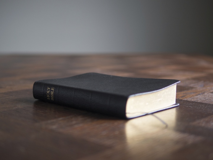 Bible laying on top of a table.