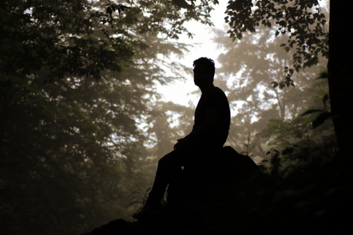 A man sitting on a rock.