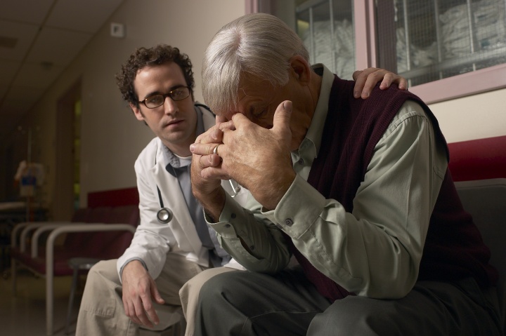 A doctor consoling a person who is grieving. 